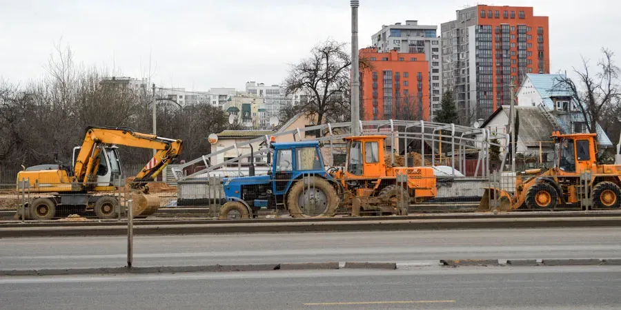 Four large construction vehicles in profile