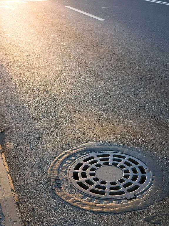 Manhole cover on asphalt