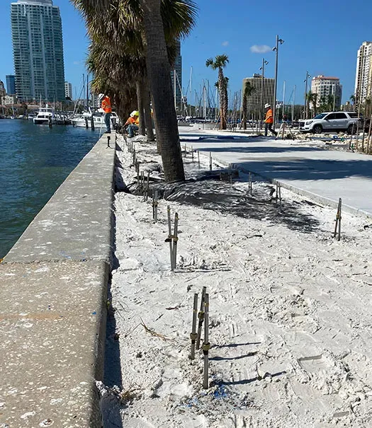 Seawall with injection tubes placed in sand
