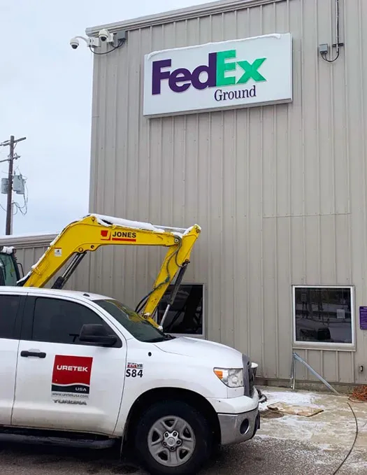 URETEK vehicle in front of FedEx warehouse