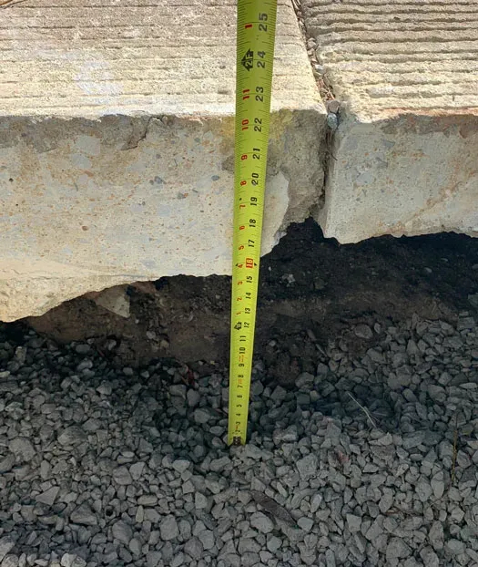 Tape measure lined up agains concrete and asphalt