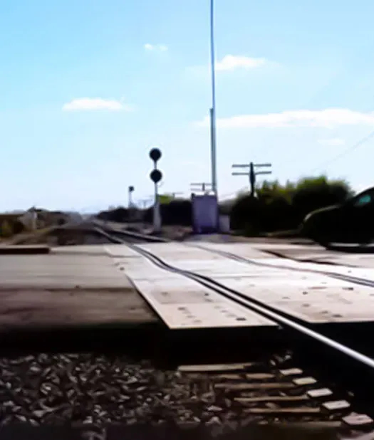Railroad crossing on sunny day