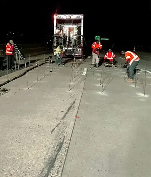 Four URETEK crews drill holes at night
