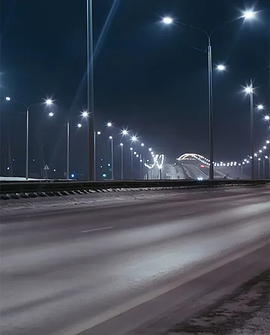 Dark roadway and white street lamps