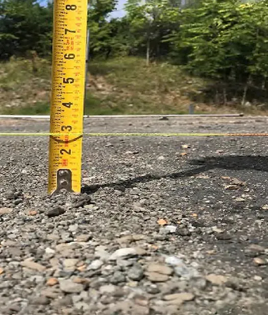 Tape measure on asphalt