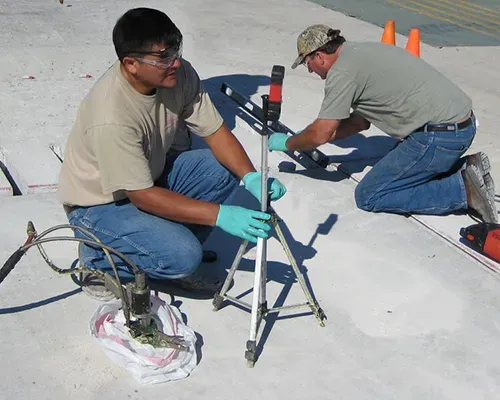 Two technicians testing ground beneath airforce runway