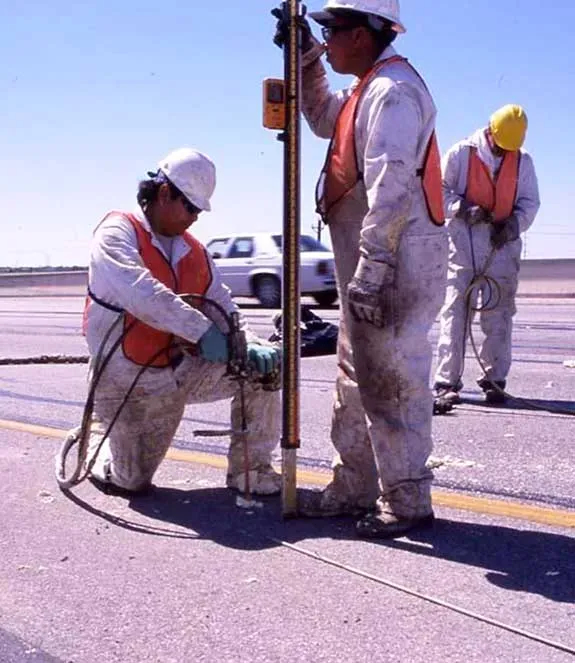 Three technicians performing URETEK Deep INjection on runway