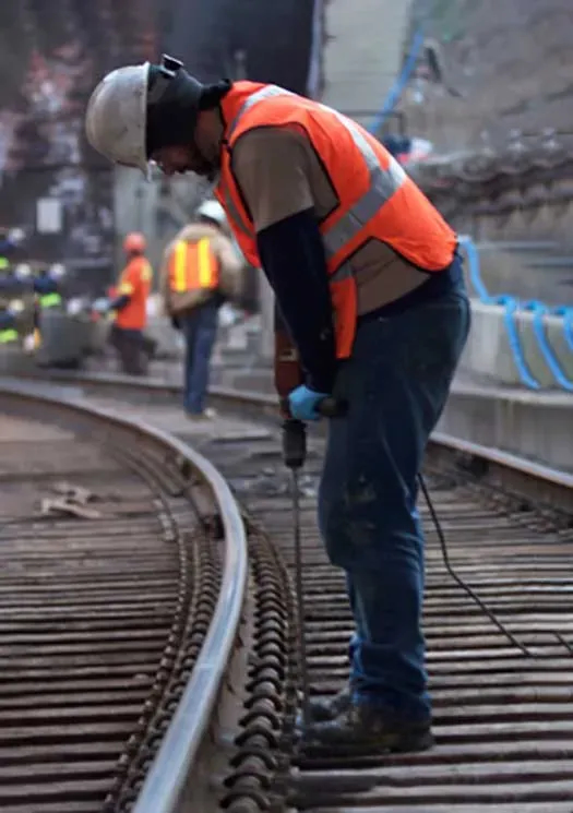 URETEK technician drilling hole into rail track