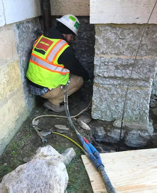 Technician with back to camera performing URETEK Deep Injection